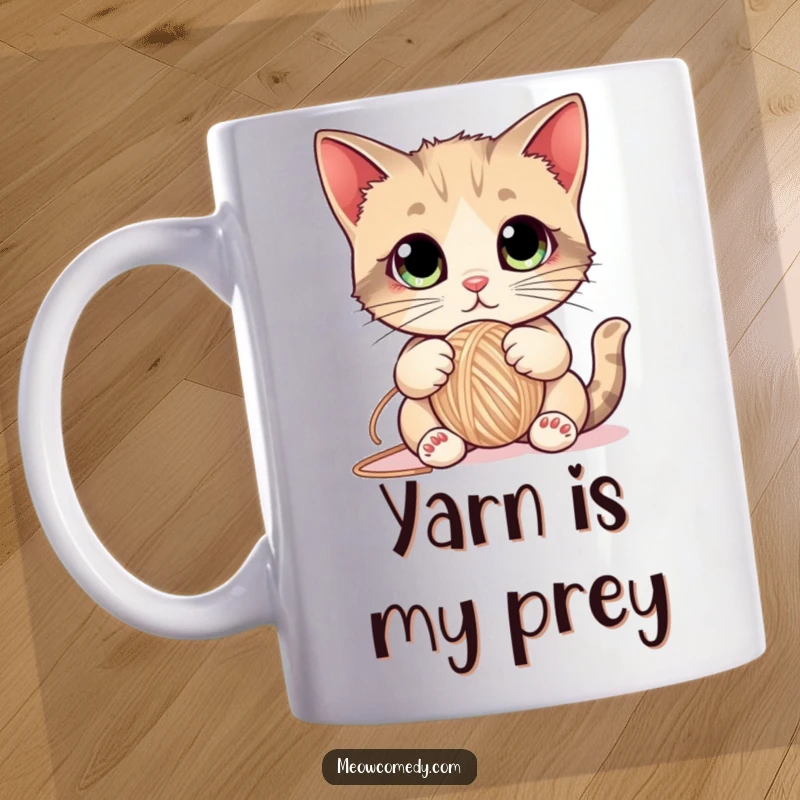 Funny Cat Mug showing a cute kitten with enormous eyes playfully batting a ball of yarn, embodying mischievous feline energy.
