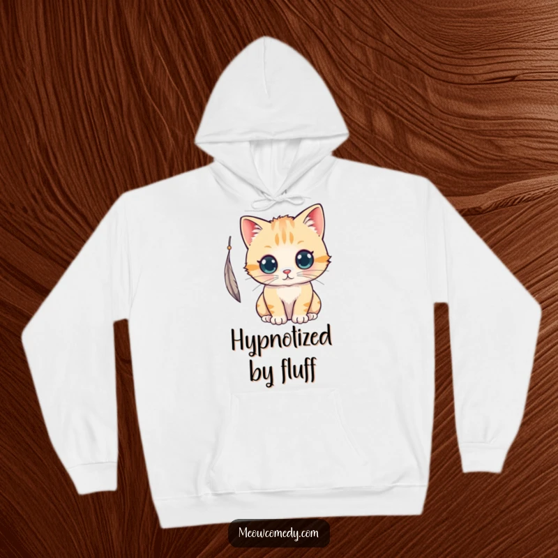 Funny kawaii cat with curious eyes, batting at a feather, a soft and humorous hoodie for ultimate comfort.