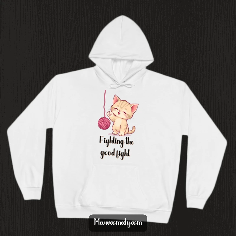 Funny Playful Kitten Hoodie: A small kitten is depicted batting playfully at a ball of yarn, perfect for a warm and humorous hoodie.