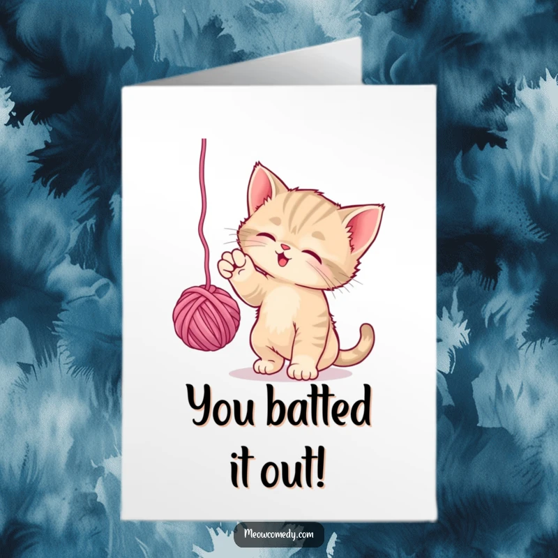 Funny free printable congratulations card of a playful kitten batting at a dangling ball of yarn, celebrating achievements.