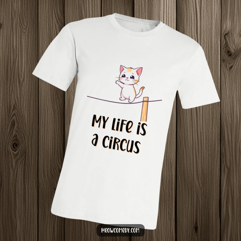 Funny t-shirt of a cat hilariously attempting to balance on a fence like a tightrope walker.