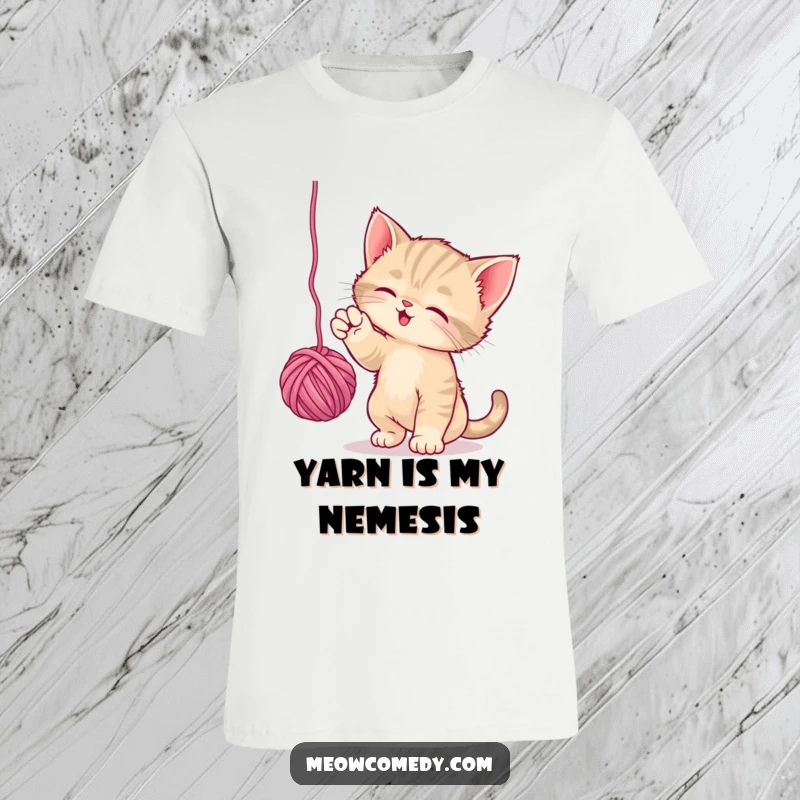 Funny Playful Kitten T-Shirt: A lively kitten is captured mid-bat as it plays with a dangling ball of yarn, full of mischief.