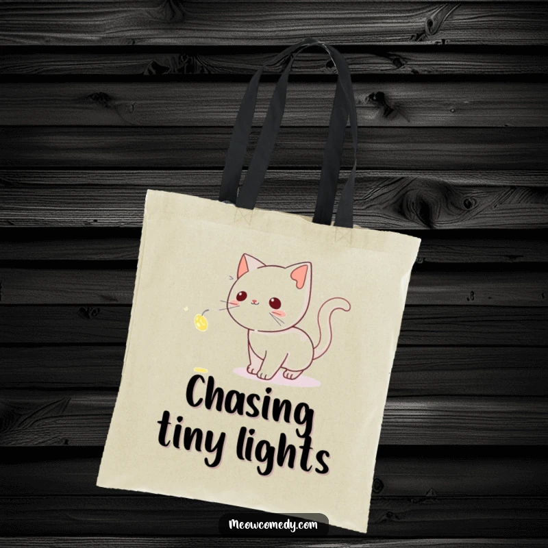 Funny Cat Tote Bag: A stealthy cat tiptoeing after a bright, shimmering firefly, perfect for carrying your magical finds.