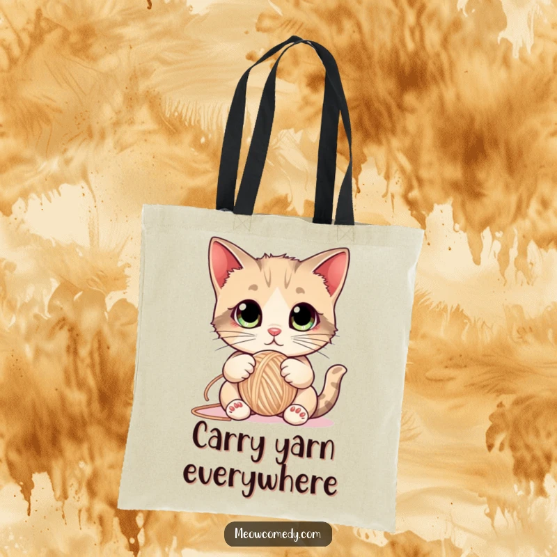 Funny Cat Tote Bag adorned with a cute kitten with large eyes playfully batting a ball of yarn, perfect for cat enthusiasts.
